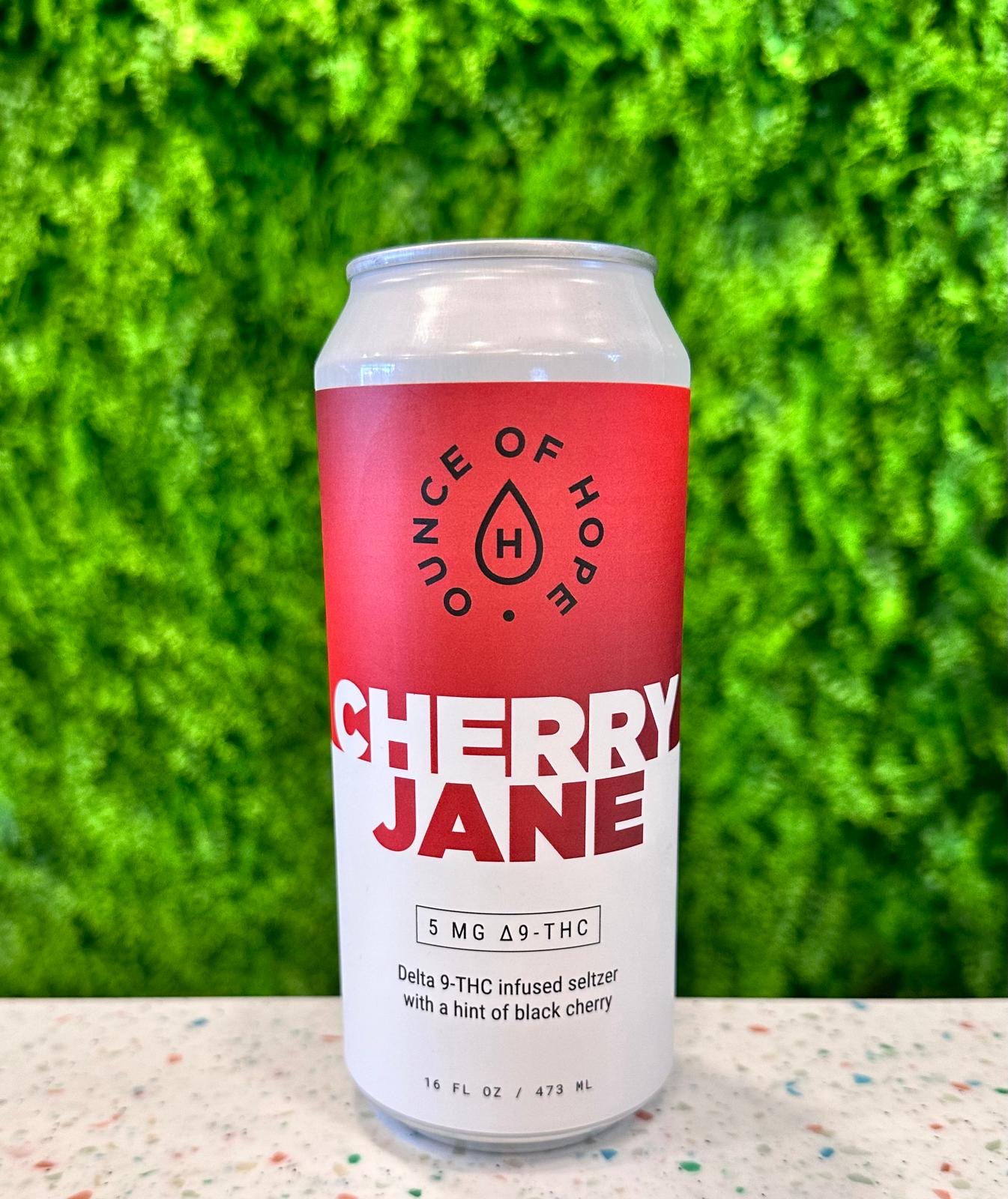 Cherry Jane in front of leafy background