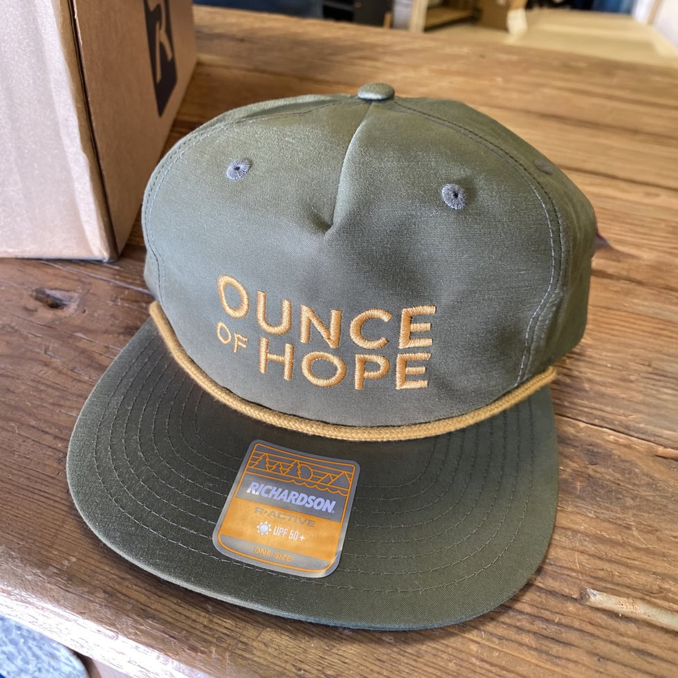 Ounce of Hope green rope hat merch